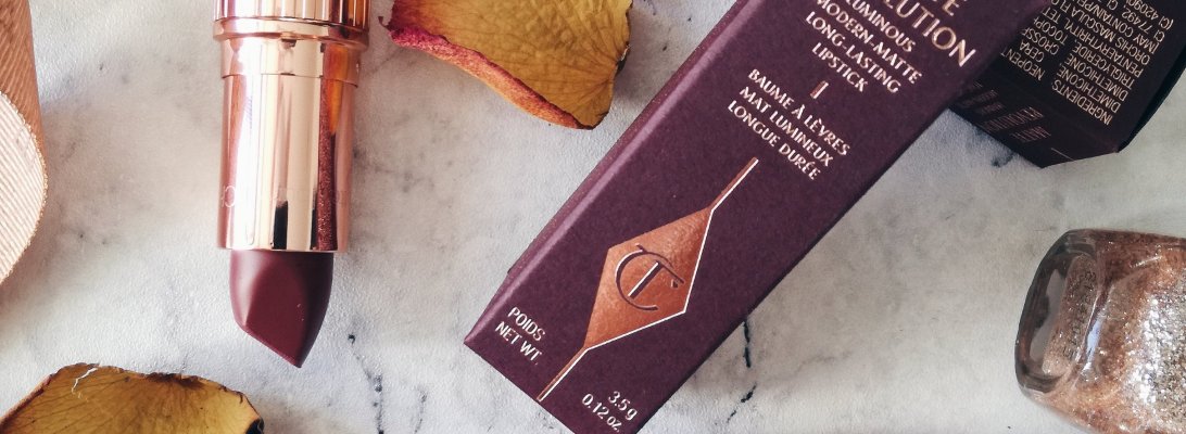 Flatlay of Charlotte Tilbury Matte Revolution lipsticks in shades Pillow Talk and Bond Girl